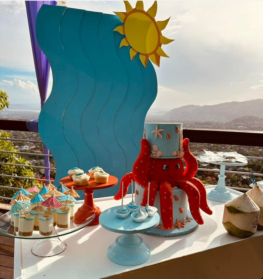 Children's birthday party setup with a red octopus cake and ocean-themed decorations.